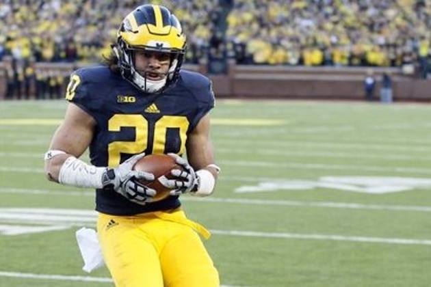 Michigan's Drake Johnson scores against Rutgers on a 1-yard run during the first half of an NCAA college football game Saturday, Nov. 7, 2015, in Ann Arbor, Mich. Michigan defeated Rutgers 49-16. (AP Photo/Duane Burleson)