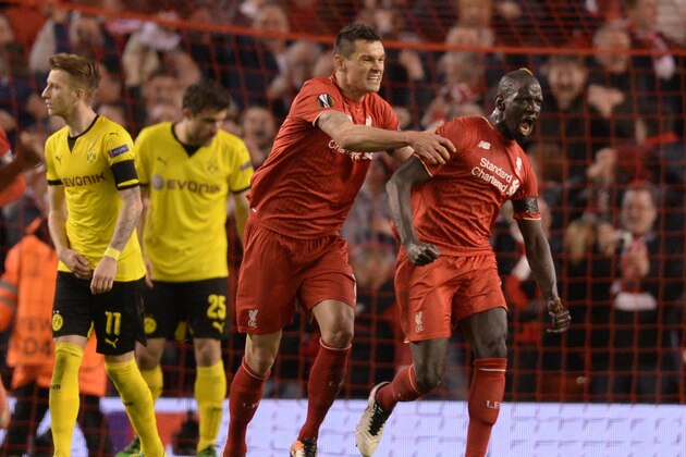 Liverpool's French defender Mamadou Sakho (R) celebrates after scoring during the UEFA Europa league quarter-final second leg football match between Liverpool  and Borussia Dortmund at Anfield stadium in Liverpool on April 14, 2016. / AFP / OLI SCARFF        (Photo credit should read OLI SCARFF/AFP/Getty Images)