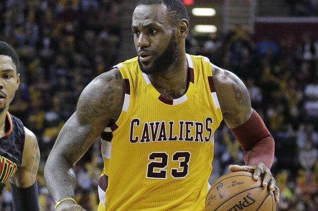 Cleveland Cavaliers' LeBron James (23) drives past Atlanta Hawks' Kent Bazemore (24) in the second half of an NBA basketball game Monday, April 11, 2016, in Cleveland. The Cavaliers won 109-94. (AP Photo/Tony Dejak)