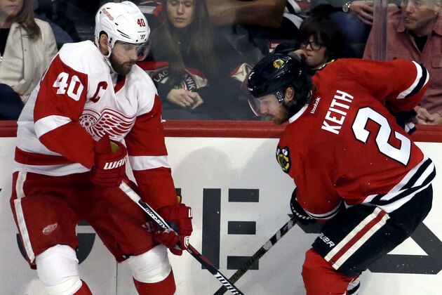 Detroit Red Wings left wing Henrik Zetterberg, left, and Chicago Blackhawks defenseman Duncan Keith battle for the puck during the third period of an NHL hockey game Sunday, March 6, 2016, in Chicago. The Blackhawks won 4-1. (AP Photo/Nam Y. Huh)