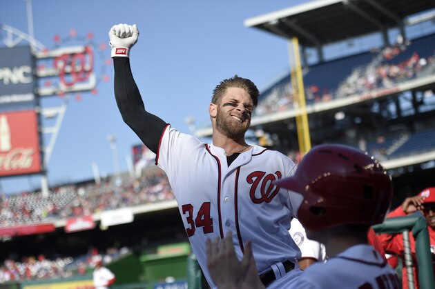 Washington Nationals' Bryce Harper pumps his fist as he takes a curtain call after he hit a grand slam during the third  inning of an baseball game against the Atlanta Braves, Thursday, April 14, 2016, in Washington. This was Harper's 100th home run of his career. (AP Photo/Nick Wass)