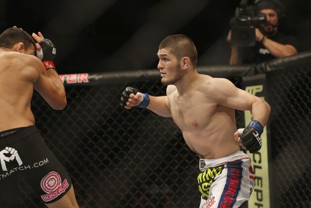 Rafael dos Anjos from Brazil, left, and Khabib Nurmagomedov from Russia fight in a mixed martial arts event on Saturday, April 19, 2014, at UFC Fight Night in Orlando Fla.. Nurmagomedov won. (AP Photo/Reinhold Matay)