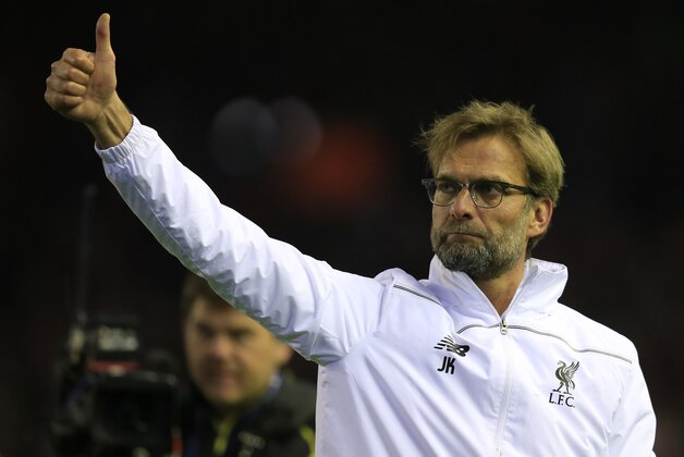 Liverpool's head coach Juergen Klopp waves to supporters after his team won the Europa League quarterfinal second leg soccer match between Liverpool  FC and Borussia Dortmund in Liverpool, England, Thursday, April 14, 2016 . (AP Photo/Jon Super)