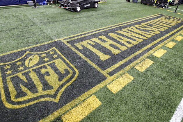 The NFL Thanksgiving logo is seen on the sideline of the field before an NFL football game between the Carolina Panthers and Dallas Cowboys, Thursday, Nov. 26, 2015, in Arlington, Texas. (AP Photo/Brandon Wade)