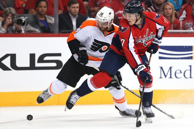 WASHINGTON, DC - APRIL 14: T.J. Oshie #77 of the Washington Capitals and Sean Couturier #14 of the Philadelphia Flyers battle for the puck during the first period in Game One of the Eastern Conference Quarterfinals during the 2015 NHL Stanley Cup Playoffs at Verizon Center on April 14, 2016 in Washington, DC. (Photo by Patrick Smith/Getty Images)