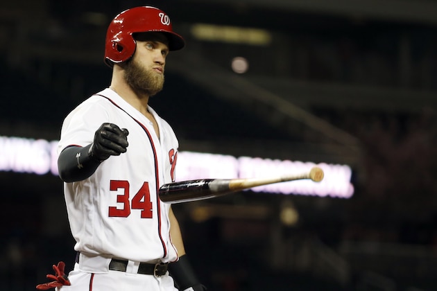 Washington Nationals' Bryce Harper tosses his bat after striking out during the eighth inning of a baseball game against the Atlanta Braves at Nationals Park, Wednesday, April 13, 2016, in Washington. The Nationals won 3-0. (AP Photo/Alex Brandon)