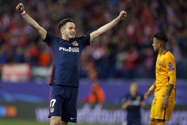Barcelona's Neymar, right, walks on the pitch as Atletico's Saul Niguez, left, celebrates after the Champions League 2nd leg quarterfinal soccer match between Atletico Madrid and Barcelona at the Vicente Calderon stadium in Madrid, Spain, Wednesday April 13, 2016. Atletico defeated Barcelona by 2-0. (AP Photo/Paul White)