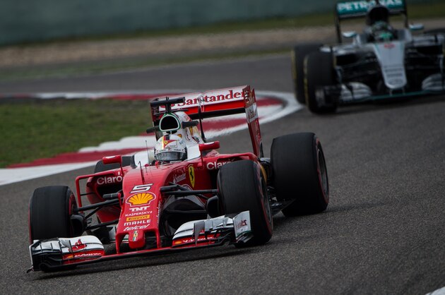 Ferrari's German driver Sebastian Vettel takes a corner in front of Mercedes AMG Petronas F1 Team's German driver Nico Rosberg during the second practice session at the Formula One Chinese Grand Prix in Shanghai on April 15, 2016. / AFP / JOHANNES EISELE        (Photo credit should read JOHANNES EISELE/AFP/Getty Images)