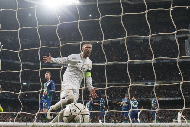 Real Madrid's defender Sergio Ramos celebrates after Real Madrid's Portuguese forward Cristiano Ronaldo scored his third goal during the Champions League quarter-final second leg football match Real Madrid vs Wolfsburg at Santiago Bernabeu stadium in Madrid on April 12, 2016. / AFP / JAVIER SORIANO        (Photo credit should read JAVIER SORIANO/AFP/Getty Images)