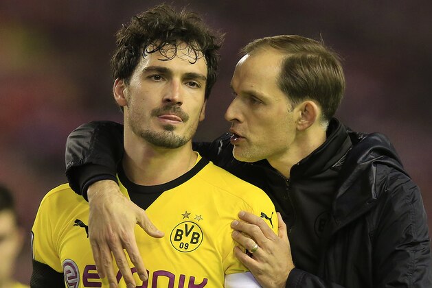 Dortmund head coach Thomas Tuchel, right, comforts Dortmund's Mats Hummels after losing the Europa League quarterfinal second leg soccer match between Liverpool  FC and Borussia Dortmund in Liverpool, England, Thursday, April 14, 2016 . (AP Photo/Jon Super)