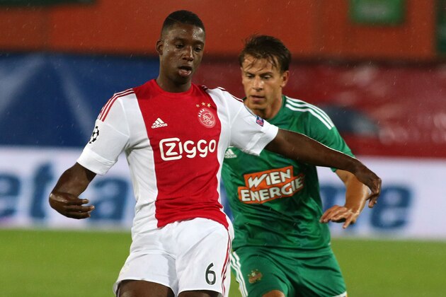 Ajax's Riechedly Bazoer, left, and Rapid's Stefan Schwab challenge for the ball during their the Champions League third qualifying round first leg soccer match between Rapid Vienna and Ajax Amsterdam in Vienna, Austria, Wednesday, July 29, 2015. (AP Photo/Ronald Zak)