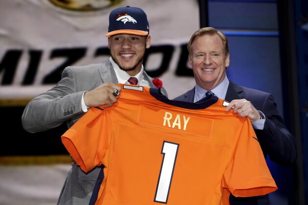 Shane Ray stands on stage with NFL commissioner Roger Goodell, right, after being drafted 23rd by the Denver Broncos during the first round of the 2015 NFL Draft, Thursday, April 30, 2015, in Chicago.  (Jeff Haynes/AP Images for Panini)