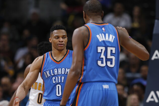 Oklahoma City Thunder guard Russell Westbrook, back, is congratulated, after scoring a basket and drawing a foul, by forward Kevin Durant during the second half of an NBA basketball game against the Denver Nuggets on Tuesday, April 5, 2016, in Denver. Oklahoma City won 124-102. (AP Photo/David Zalubowski)
