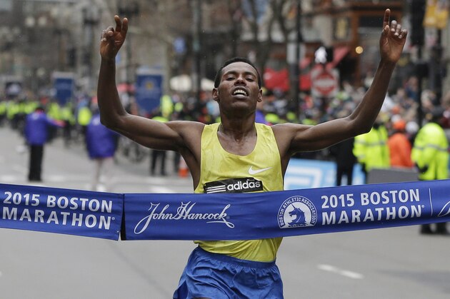 Lelisa Desisa, of Ethiopia, crosses the finish line to win the men's division of the Boston Marathon, Monday, April 20, 2015, in Boston. (AP Photo/Elise Amendola)