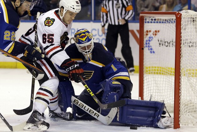 Chicago Blackhawks' Andrew Shaw, left, scores past St. Louis Blues goalie Brian Elliott during the third period in Game 2 of an NHL hockey first-round Stanley Cup playoff series Friday, April 15, 2016, in St. Louis. (AP Photo/Jeff Roberson)