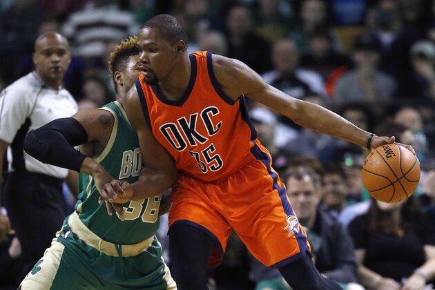 Oklahoma City Thunder's Kevin Durant (35) looks to move on Boston Celtics' Marcus Smart (36) during the first quarter of an NBA basketball game in Boston, Wednesday, March 16, 2016. The Thunder won 130-109. (AP Photo/Michael Dwyer)