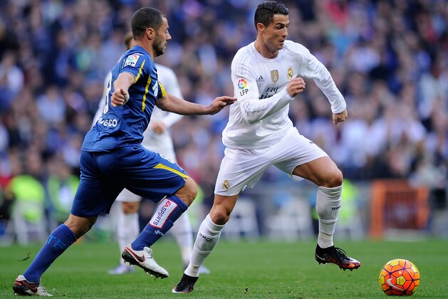 MADRID, SPAIN - DECEMBER 05:  Cristiano Ronaldo of Real Madrid takes on Mehdi Lacen of Getafe during the La Liga match between Real Madrid CF and Getafe CF at Estadio Santiago Bernabeu on December 5, 2015 in Madrid, Spain.  (Photo by Denis Doyle/Getty Images)