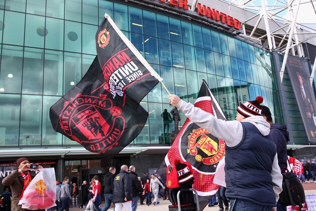 MANCHESTER, ENGLAND - APRIL 16:  Manchester United fans wave their flags prior to the Barclays Premier League match between Manchester United and Aston Villa at Old Trafford on April 16, 2016 in Manchester, England.  (Photo by Clive Brunskill/Getty Images)
