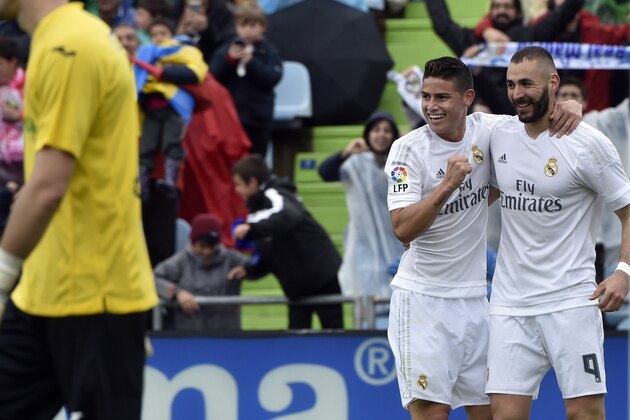 Real Madrid's French forward Karim Benzema (R) celebrates a goal with Real Madrid's Colombian midfielder James Rodriguez during the Spanish league football match Getafe CF vs Real Madrid CF at the Coliseum Alfonso Perez stadium in Getafe on April 16, 2016. / AFP / GERARD JULIEN        (Photo credit should read GERARD JULIEN/AFP/Getty Images)