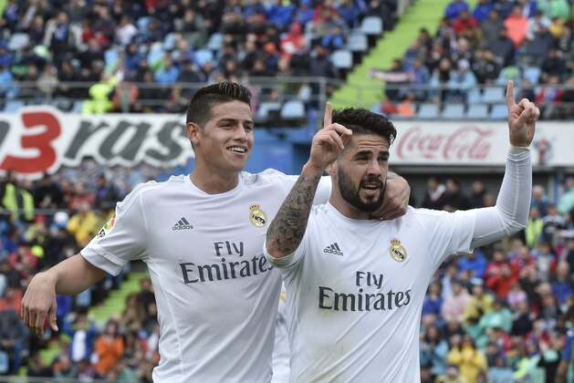 Real Madrid's midfielder Isco (R) celebrates a goal with Real Madrid's Colombian midfielder James Rodriguez during the Spanish league football match Getafe CF vs Real Madrid CF at the Coliseum Alfonso Perez stadium in Getafe on April 16, 2016. / AFP / GERARD JULIEN        (Photo credit should read GERARD JULIEN/AFP/Getty Images)