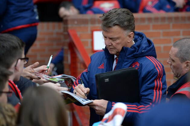 Manchester United's Dutch manager Louis van Gaal signs autographs  before the English Premier League football match between Manchester United and Aston Villa at Old Trafford in Manchester, north west England, on April 16, 2016. / AFP / OLI SCARFF / RESTRICTED TO EDITORIAL USE. No use with unauthorized audio, video, data, fixture lists, club/league logos or 'live' services. Online in-match use limited to 75 images, no video emulation. No use in betting, games or single club/league/player publications.  /         (Photo credit should read OLI SCARFF/AFP/Getty Images)