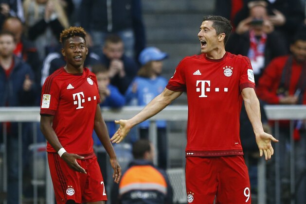 Bayern's Robert Lewandowski, right, celebrates after scoring his side's second goal during the German Bundesliga soccer match between FC Bayern Munich and FC Schalke 04 at the Allianz Arena stadium in Munich, Germany, Saturday, April 16, 2016. (AP Photo/Matthias Schrader)