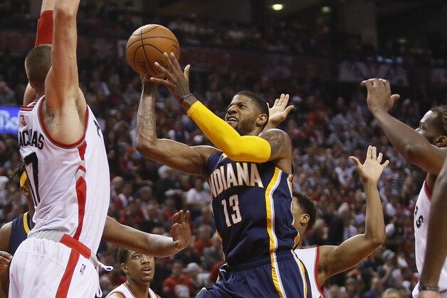 Apr 16, 2016; Toronto, Ontario, CAN; Indiana Pacers forward Paul George (13) goes up to make a basket as Toronto Raptors center Jonas Valanciunas (17) defends during the first half of game one of the first round of the 2016 NBA Playoffs at Air Canada Centre. Mandatory Credit: John E. Sokolowski-USA TODAY Sports