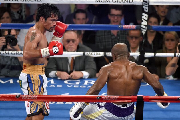 LAS VEGAS, NEVADA - APRIL 09:  Manny Pacquiao (L) knocks down Timothy Bradley Jr. in the ninth round of their welterweight fight at MGM Grand Garden Arena on April 9, 2016 in Las Vegas, Nevada. Pacquiao won by unanimous decision.  (Photo by Ethan Miller/Getty Images)