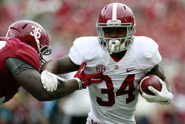 Apr 16, 2016; Tuscaloosa, AL, USA; Alabama Crimson Tide running back Damien Harris (34) is grabbed by Alabama Crimson Tide defensive lineman Johnny Dwight (36) during the annual A-day game at Bryant-Denny Stadium. Mandatory Credit: Marvin Gentry-USA TODAY Sports