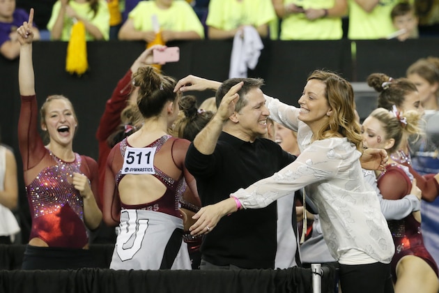 Oklahoma assistant coach Lou Ball, center left, and head coach K.J. Kindler, center right, celebrate with their team after winning the NCAA women's gymnastics championships, Saturday, April 16, 2016, in Fort Worth, Texas. (AP Photo/Tony Gutierrez)