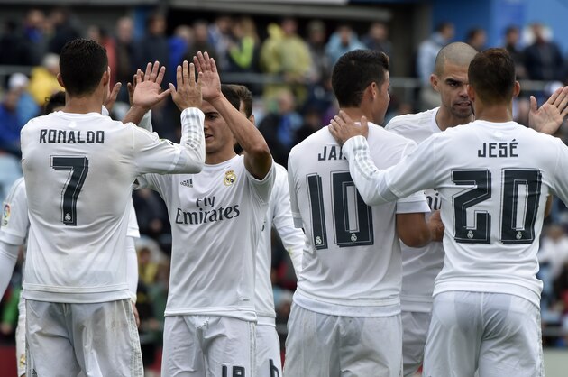 Real Madrid's Portuguese forward Cristiano Ronaldo (L) celebrates a goal with teammates during the Spanish league football match Getafe CF vs Real Madrid CF at the Coliseum Alfonso Perez stadium in Getafe on April 16, 2016. Real Madrid won 5-1. / AFP / GERARD JULIEN        (Photo credit should read GERARD JULIEN/AFP/Getty Images)