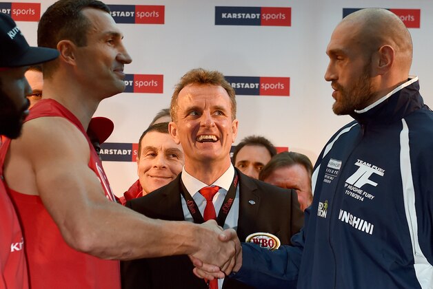 Ukrainian Heavyweight World Champion Wladimir Klitschko (L) shakes hands with his challenger Britain's Tyson Fury during an official weigh-in in Essen, western Germany on November 27, 2015. World heavyweight champion Klitschko will defend his IBF, WBA and IBO titles against British challenger Tyson Fury in Duesseldorf on November 28, 2015. AFP PHOTO / PATRIK STOLLARZ / AFP / PATRIK STOLLARZ        (Photo credit should read PATRIK STOLLARZ/AFP/Getty Images)