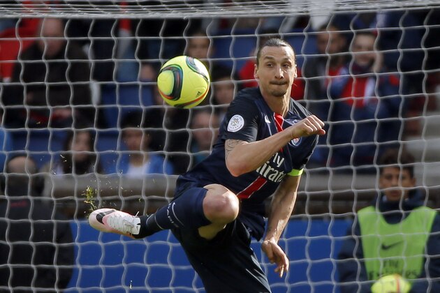 PSG's Zlatan Ibrahimovic, left, controls the ball during their French League One soccer match between PSG and Caen at the Parc des Princes stadium in Paris, France, Saturday, April 16, 2016. (AP Photo/Francois Mori)