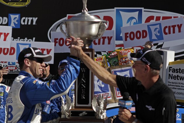 Carl Edwards, left, celebrates with Steve Smith, the president and CEO of Food City, after winning a NASCAR Sprint Cup Series auto race, Sunday, April 17, 2016, in Bristol, Tenn. (AP Photo/Wade Payne)