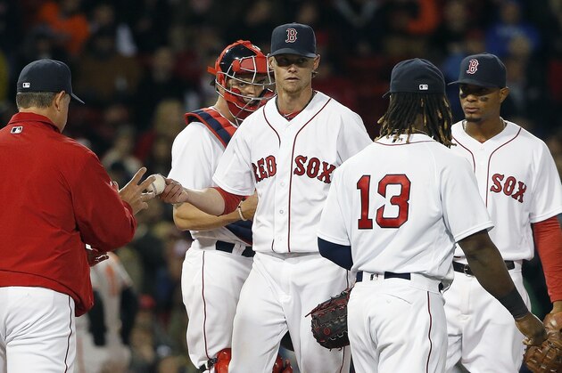Boston Red Sox's Clay Buchholz, center, hands the ball to manager John Farrell, left, as he is taken out of the baseball game during the sixth inning against the Baltimore Orioles in Boston, Tuesday, April 12, 2016. (AP Photo/Michael Dwyer)