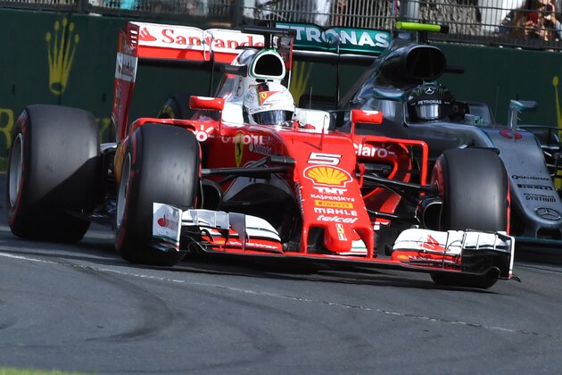 Ferrari's German driver Sebastian Vettel (L) powers through a corner ahead of Mercedes AMG Petronas F1 Team's German driver Nico Rosberg (R) during the Formula One Australian Grand Prix in Melbourne on March 20, 2016.  / AFP / Paul Crock / IMAGE RESTRICTED TO EDITORIAL USE - STRICTLY NO COMMERCIAL USE        (Photo credit should read PAUL CROCK/AFP/Getty Images)