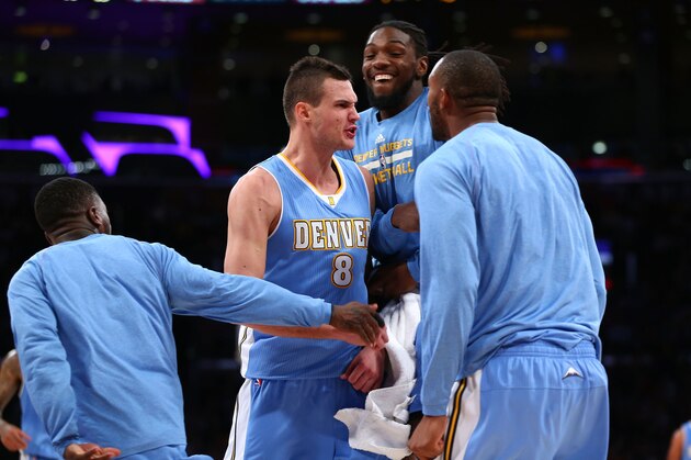 LOS ANGELES, CA - NOVEMBER 23:  Danilo Gallinari #8 of the Denver Nuggets celebrates with Kenneth Faried #35 and teammates after making a three point shot in overtime against the Los Angeles Lakers during the NBA game at Staples Center on November 23, 2014 in Los Angeles, California. The Nuggets defeated the Lakers 107-91. NOTE TO USER: User expressly acknowledges and agrees that, by downloading and or using this photograph, User is consenting to the terms and conditions of the Getty Images License Agreement.  (Photo by Victor Decolongon/Getty Images)