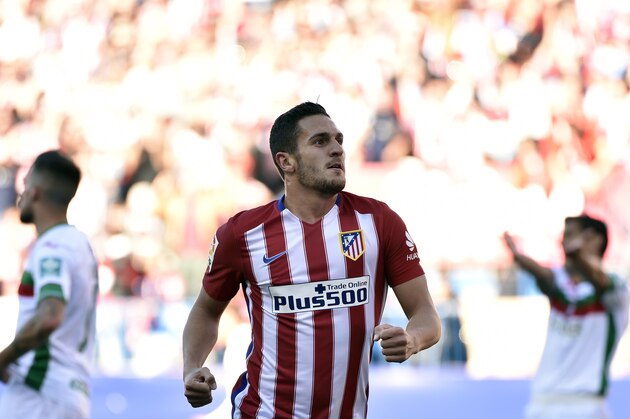 Atletico Madrid's midfielder Koke celebrates after scoring during the Spanish league football match Atletico de Madrid vs Granada CF at the Vicente Calderon stadium in Madrid on April 17, 2016. / AFP / GERARD JULIEN        (Photo credit should read GERARD JULIEN/AFP/Getty Images)