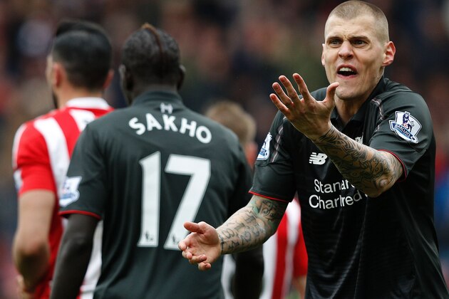 Liverpool's Slovakian defender Martin Skrtel (R) reacts after Referee Roger East (not pictured) showed him a yellow card following his challenge on Southampton's Italian striker Graziano Pelle (not pictured), and awarding Southampton a penalty during the English Premier League football match between Southampton and Liverpool at St Mary's Stadium in Southampton, southern England on March 20, 2016. / AFP / ADRIAN DENNIS / RESTRICTED TO EDITORIAL USE. No use with unauthorized audio, video, data, fixture lists, club/league logos or 'live' services. Online in-match use limited to 75 images, no video emulation. No use in betting, games or single club/league/player publications.  /         (Photo credit should read ADRIAN DENNIS/AFP/Getty Images)