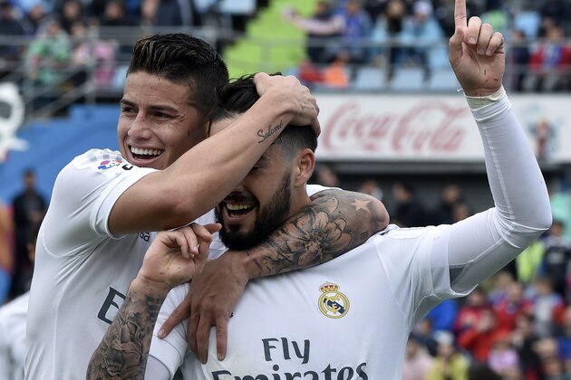 Real Madrid's midfielder Isco celebrates a goal with Real Madrid's Colombian midfielder James Rodriguez (L) during the Spanish league football match Getafe CF vs Real Madrid CF at the Coliseum Alfonso Perez stadium in Getafe on April 16, 2016. / AFP / GERARD JULIEN        (Photo credit should read GERARD JULIEN/AFP/Getty Images)