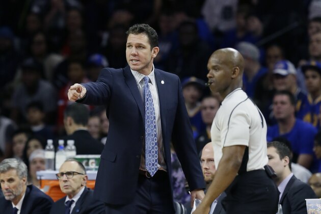 Golden State Warriors interim coach Luke Walton talks with referee Dedric Taylor on the sidelines during the second half of an NBA basketball game against the Detroit Pistons, Saturday, Jan. 16, 2016 in Auburn Hills, Mich. (AP Photo/Carlos Osorio)