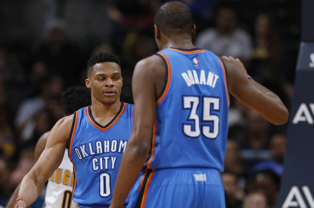 Oklahoma City Thunder guard Russell Westbrook, back, is congratulated, after scoring a basket and drawing a foul, by forward Kevin Durant during the second half of an NBA basketball game against the Denver Nuggets on Tuesday, April 5, 2016, in Denver. Oklahoma City won 124-102. (AP Photo/David Zalubowski)