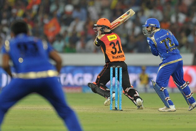 Sunrisers Hyderabad captain David Warner (C) plays a shot during the 2016 Indian Premier League (IPL) Twenty20 cricket match between Sunrisers Hyderabad and Mumbai Indians at The Rajiv Gandhi International Stadium in Hyderabad on April 18, 2016. / AFP / NOAH SEELAM / ----IMAGE RESTRICTED TO EDITORIAL USE - STRICTLY NO COMMERCIAL USE----- / GETTYOUT        (Photo credit should read NOAH SEELAM/AFP/Getty Images)