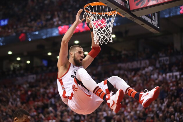 TORONTO, CANADA - APRIL 16: Jonas Valanciunas #17 of the Toronto Raptors holds on to the rim after dunking the ball against the Indiana Pacers in Game One of the Eastern Conference Quarterfinals during the 2016 NBA Playoffs on April 16, 2016 at the Air Canada Centre in Toronto, Ontario, Canada. NOTE TO USER: User expressly acknowledges and agrees that, by downloading and or using this photograph, User is consenting to the terms and conditions of the Getty Images License Agreement. (Photo by Tom Szczerbowski/Getty Images)