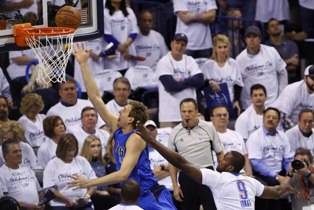 Dallas Mavericks forward Dirk Nowitzki (41) goes to the basket past Oklahoma City Thunder forward Serge Ibaka (9) during the first half of Game 2 of a first-round NBA basketball playoff series, Monday, April 18, 2016, in Oklahoma City. (AP Photo/Alonzo Adams)