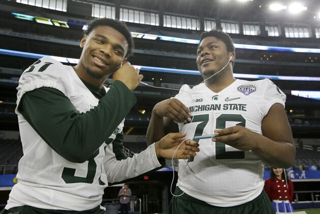 Michigan State linebacker T.J. Harrell (31) and defensive tackle Craig Evans (72) listen to music together during the media day for the NCAA Cotton Bowl college football game Tuesday, Dec. 29, 2015, in Arlington, Texas. (AP Photo/LM Otero)