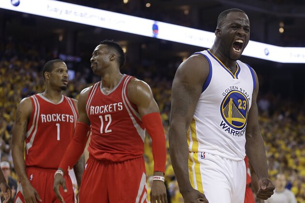 Golden State Warriors' Draymond Green, right, yells after being fouled by Houston Rockets' Dwight Howard (12) during the second half in Game 2 of a first-round NBA basketball playoff series Monday, April 18, 2016, in Oakland, Calif. The Warriors won, 115-106. At left is Rockets' Trevor Ariza (1). (AP Photo/Ben Margot)