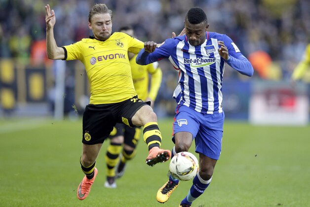 Dortmund's Marcel Schmelzer, left, and Berlin's Salomon Kalou, right, challenge for the ball during the German Bundesliga soccer match between Hertha BSC Berlin and Borussia Dortmund in Berlin, Germany, Saturday, Feb. 6, 2016. (AP Photo/Michael Sohn)