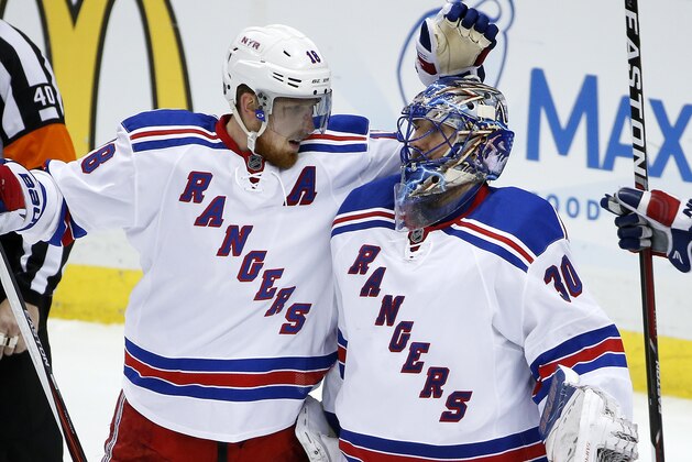 New York Rangers goalie Henrik Lundqvist (30)  and  Marc Staal (18) embrace after their 4-2 win over the Pittsburgh Penguins in Game 2 in the first round of the NHL Stanley Cup playoffs in Pittsburgh, Saturday, April 16, 2016. (AP Photo/Gene J. Puskar)