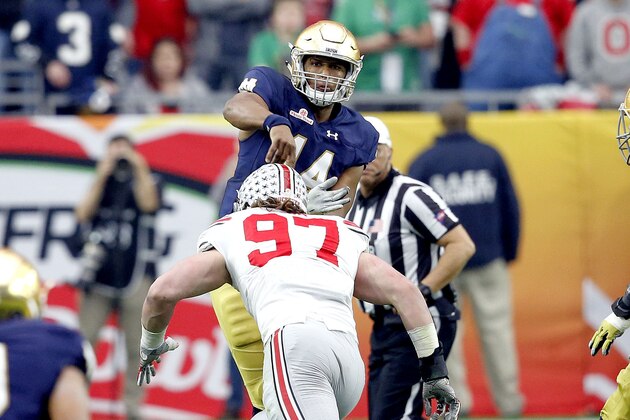 Notre Dame quarterback DeShone Kizer (14) throws a pass Ohio State defensive lineman Joey Bosa (97) leans in for a hit during the first half of the Fiesta Bowl NCAA College football game, Friday, Jan. 1, 2016, in Glendale, Ariz. Bosa was called for targeting on the hit and was ejected from the game. (AP Photo/Ross D. Franklin)